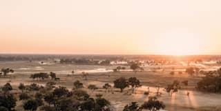 A misty aerial sunrise view of Okavango Delta at the heart of the Botswana wetlands